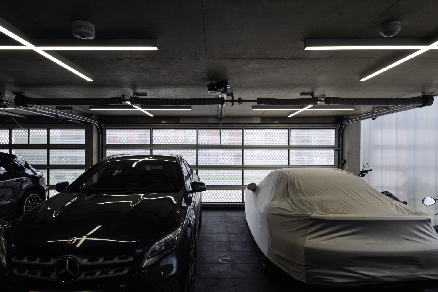 GARAGEHABITAT: The ground floor is a translucent pavilion opening to 4 orientations, of which 2 openings are suitable for vehicles. 4 vehicles can be housed in this volume, while a monolith of compactable shelves condenses household. 2001 S.à R.L.